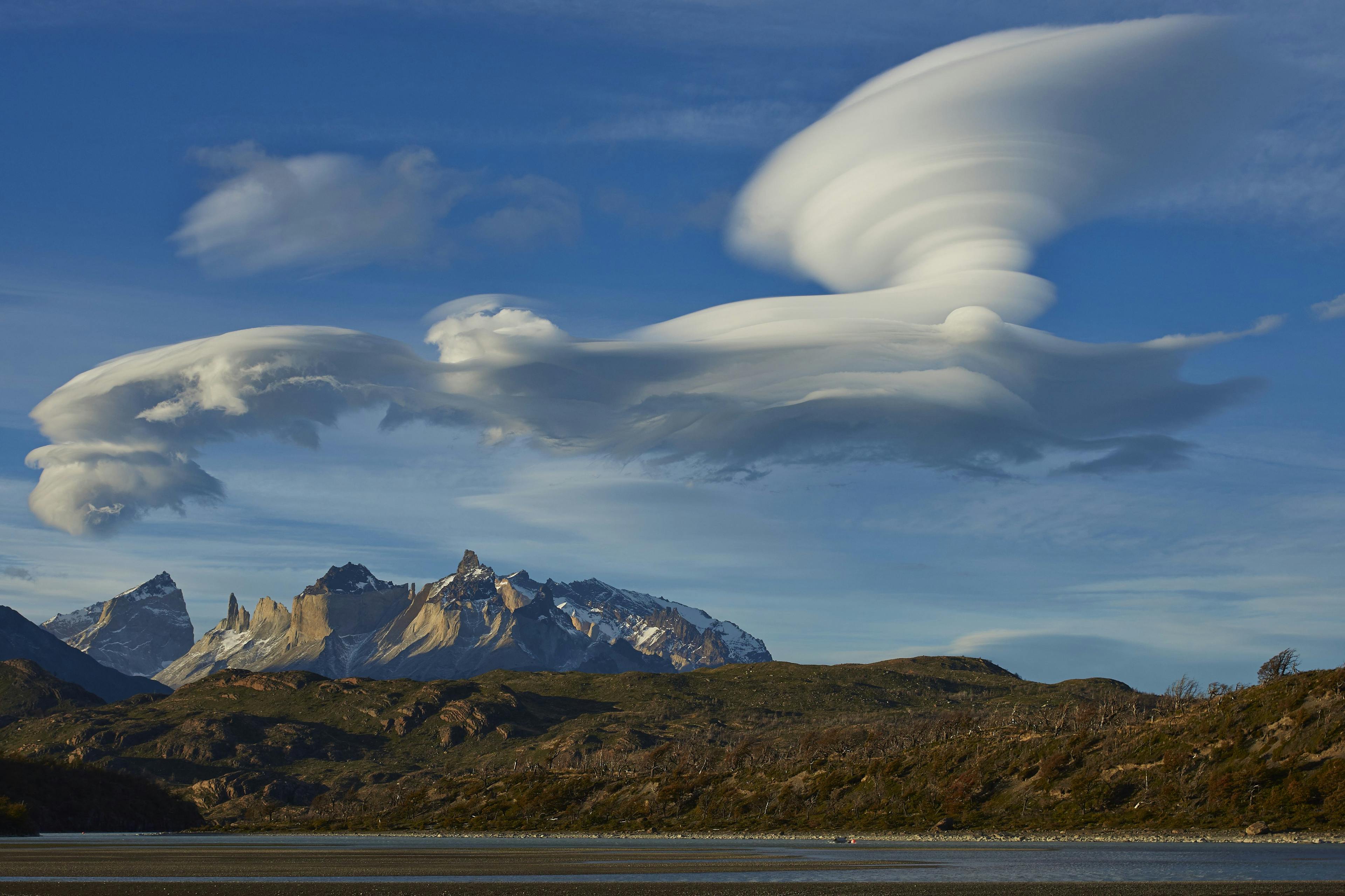 Lenticular cloud formation over a beautiful mountain range