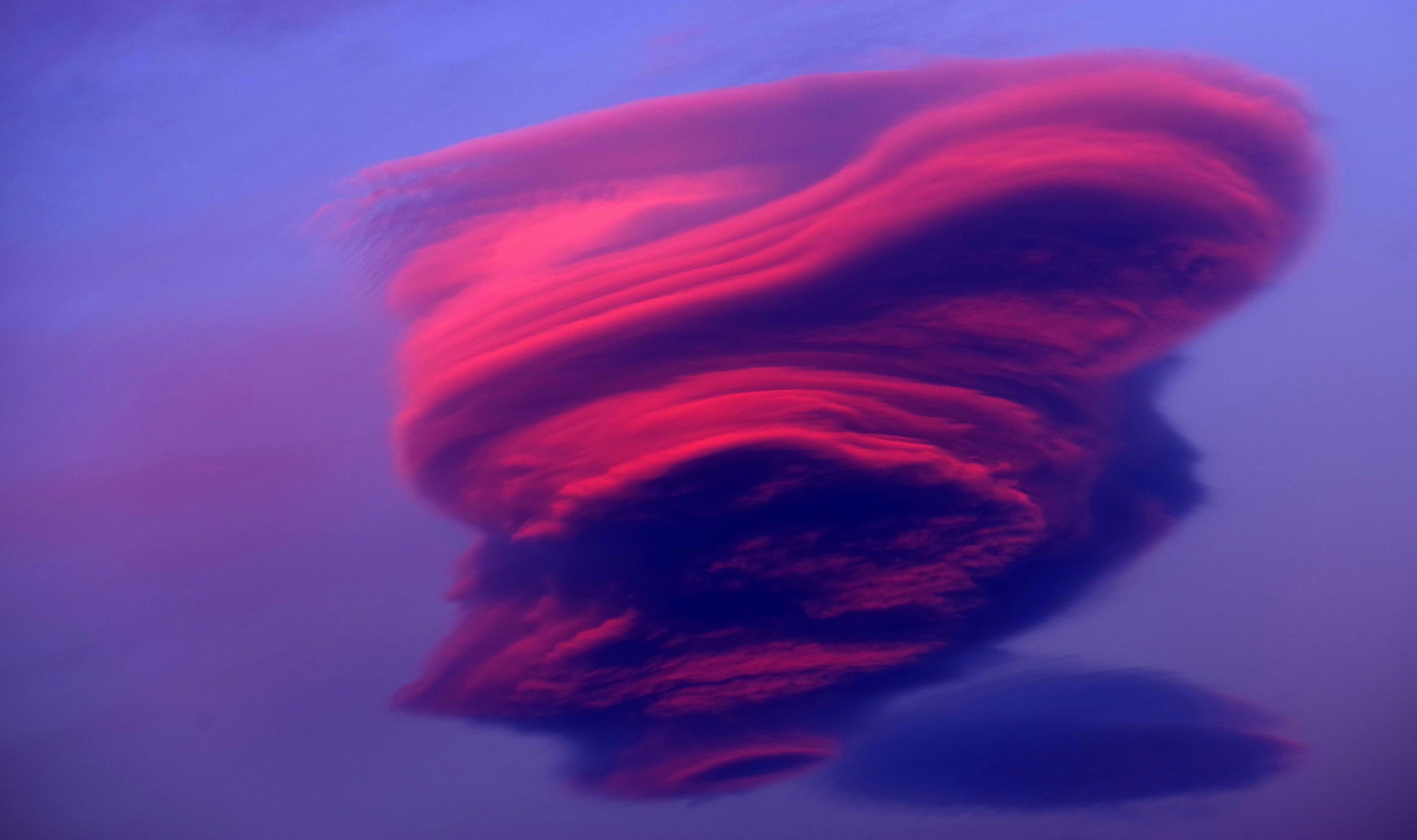 Lenticular Clouds glowing bright red in the evening
